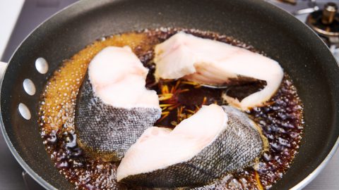 Adding the cod to the braising liquid for Soy Sauce Braised Black Cod (Gindara Nitsuke)