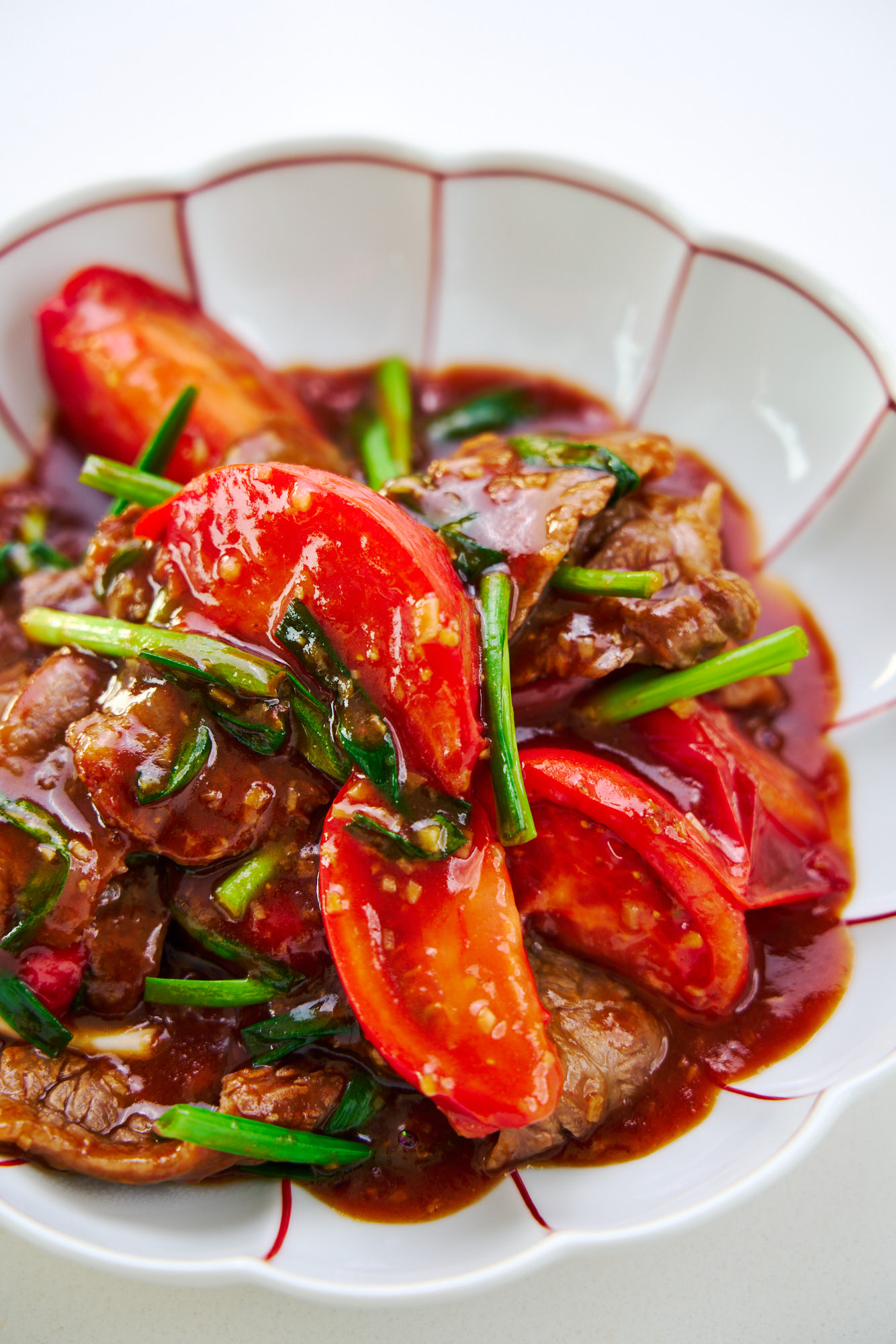 Stir-fried steak and tomatoes with scallions, garlic and ginger.