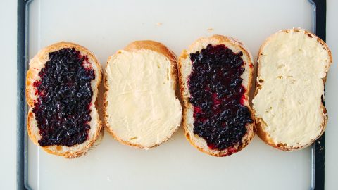 Blackberry jam on bread for Blackberry Gouda Grilled Cheese Sandwich
