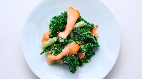 Placing salmon on the broccolini for Broccolini with Smoked Salmon and Eggs