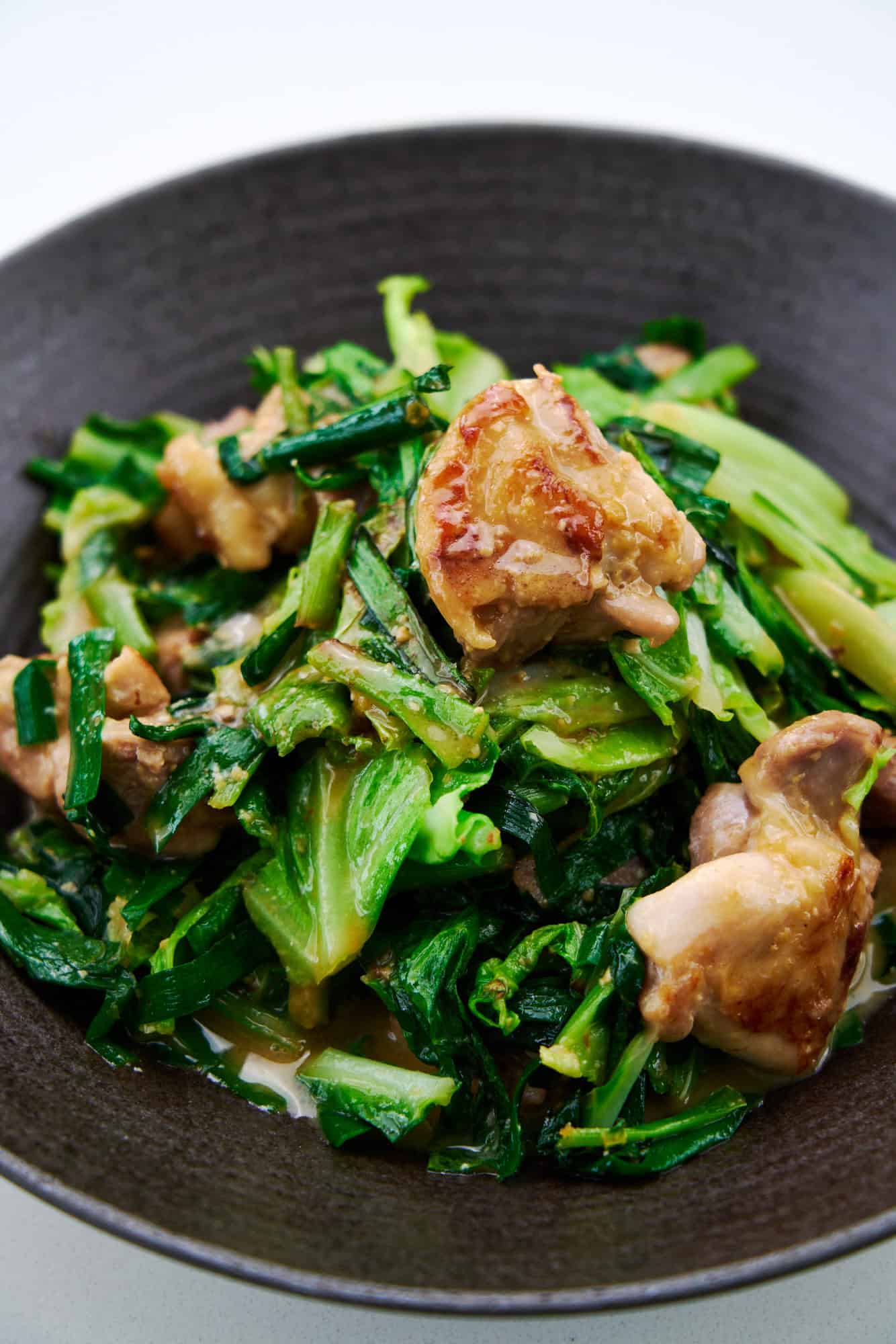 Easy weeknight miso butter chicken stir-fry with cabbage and garlic chives.