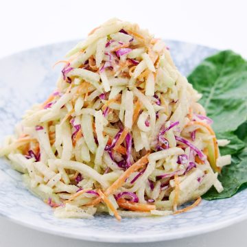 A mountain of crunchy kohlrabi coleslaw dressed with tangry and creamy cashew dressing.
