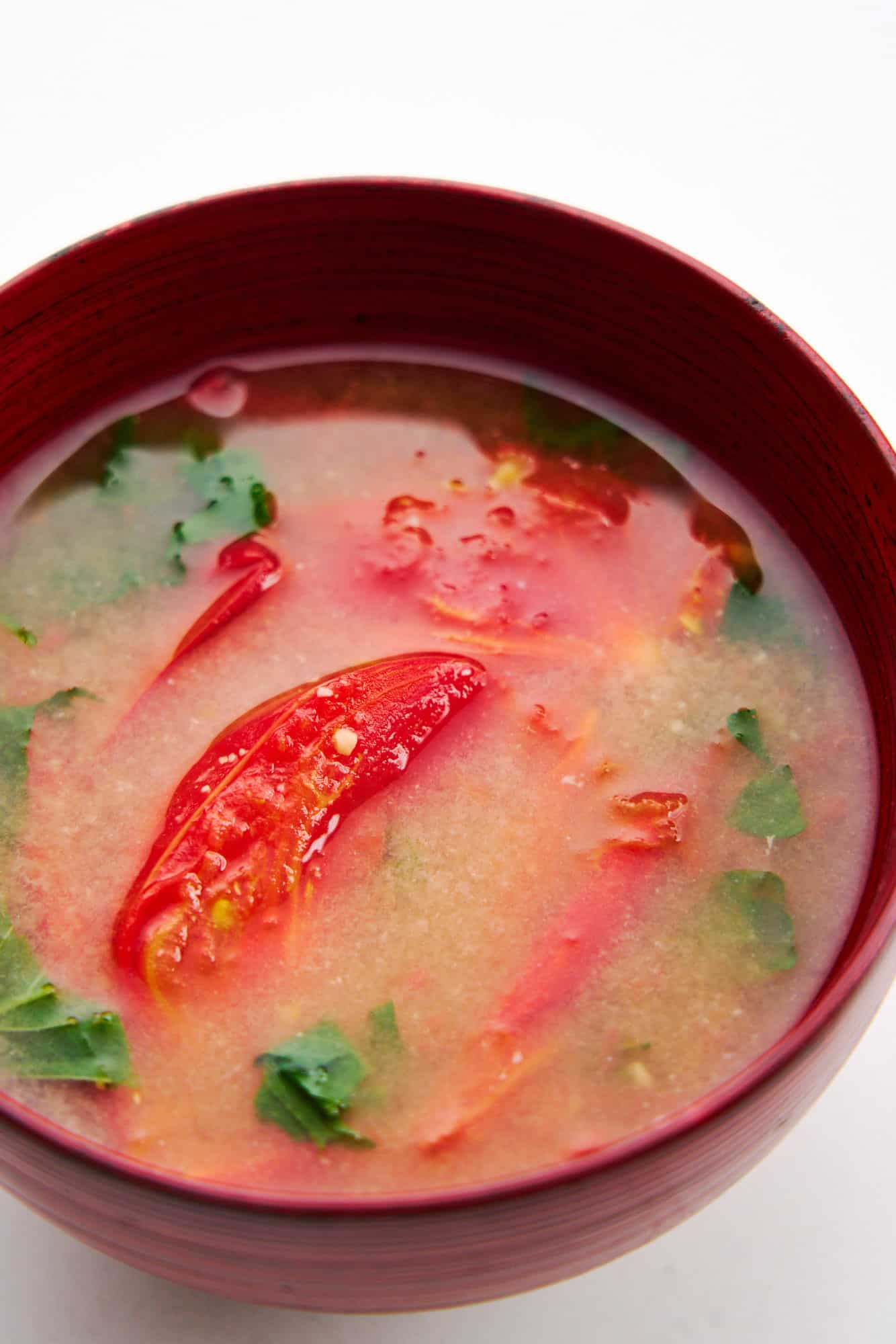Summer miso soup with sun ripened tomatoes and fresh shiso leaves.