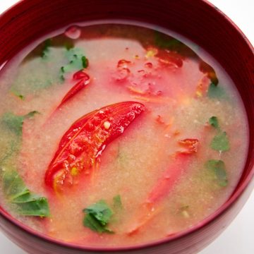 Summer miso soup with sun ripened tomatoes and fresh shiso leaves.