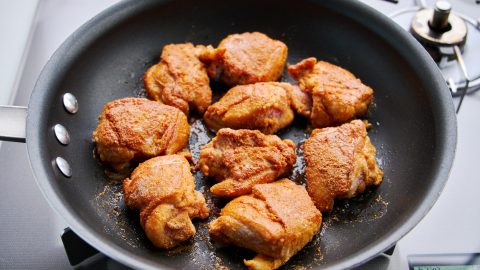 Kinako chicken browning in a frying pan.