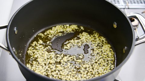 Chopped garlic sauteing in olive oil.