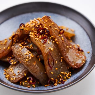 Spicy pan-fried konnyaku glazed in a savory sweet sauce with toasted sesame seeds and chili flakes.