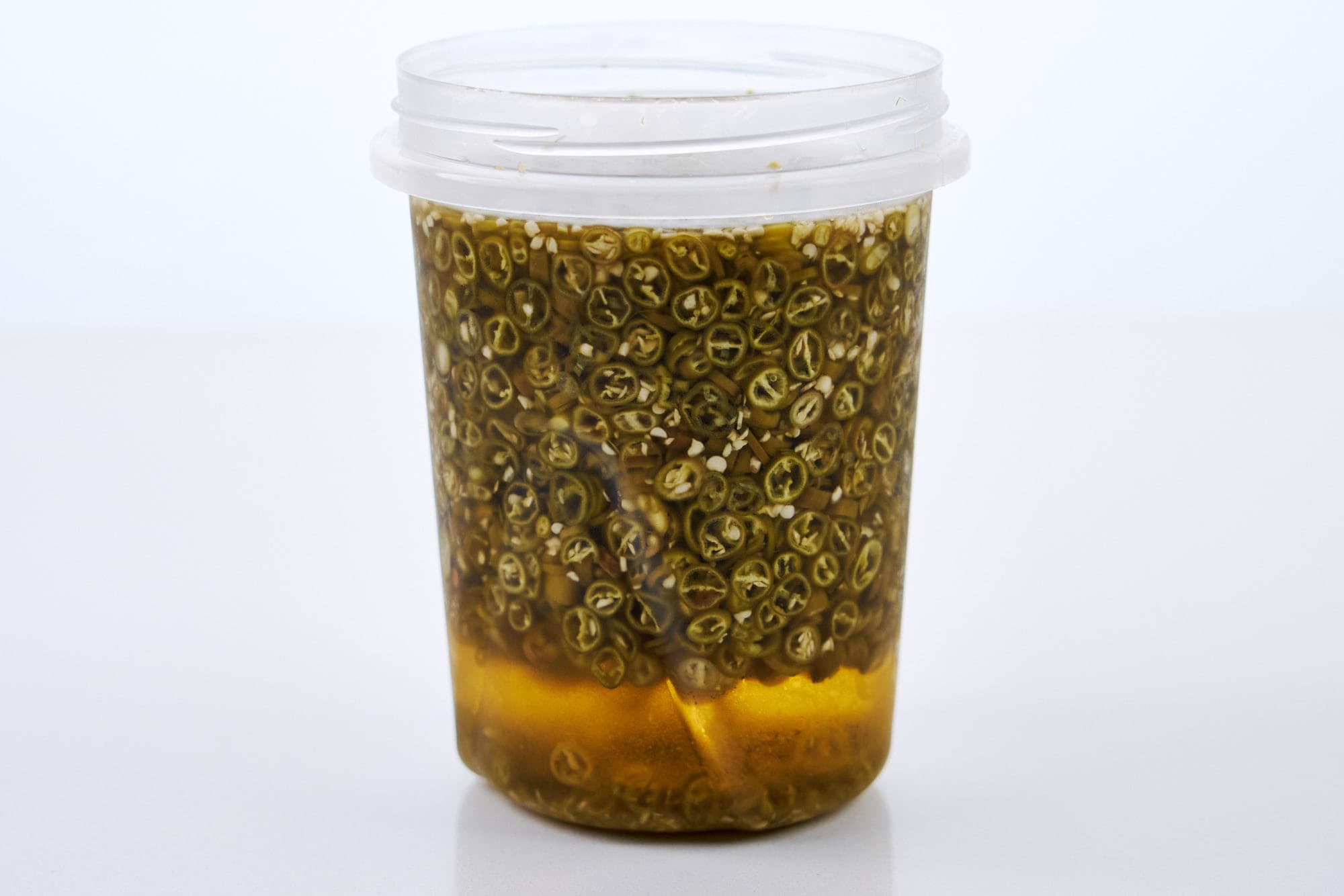 Container of pickled Japanese togarashi pepper.