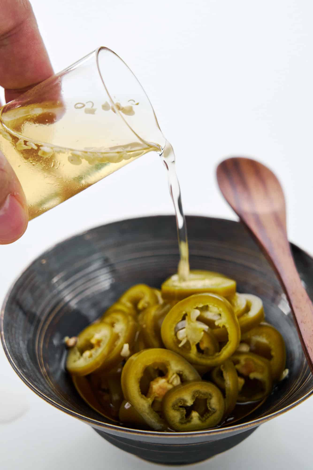 This pickled chili pepper recipe creates pickled jalapenos and spicy chili vinegar.