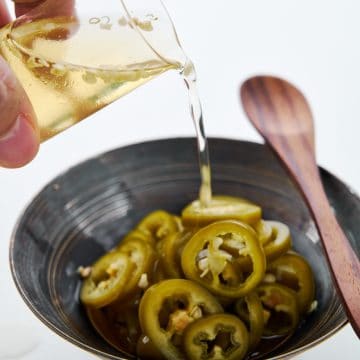 This pickled chili pepper recipe creates pickled jalapenos and spicy chili vinegar.