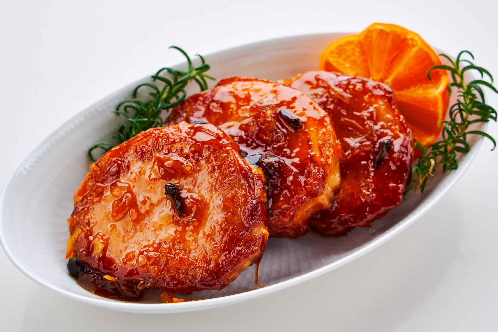 Ham steaks glazed with orange marmalade and spices.