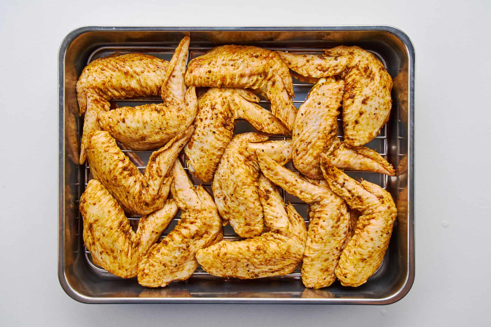 Wings air drying on a tray.