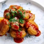 Crispy fried potatoes with a spicy sauce.