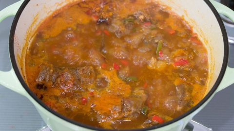 Goulash simmering in a pot.