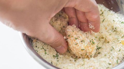 Coating nuggets in breadcrumbs.