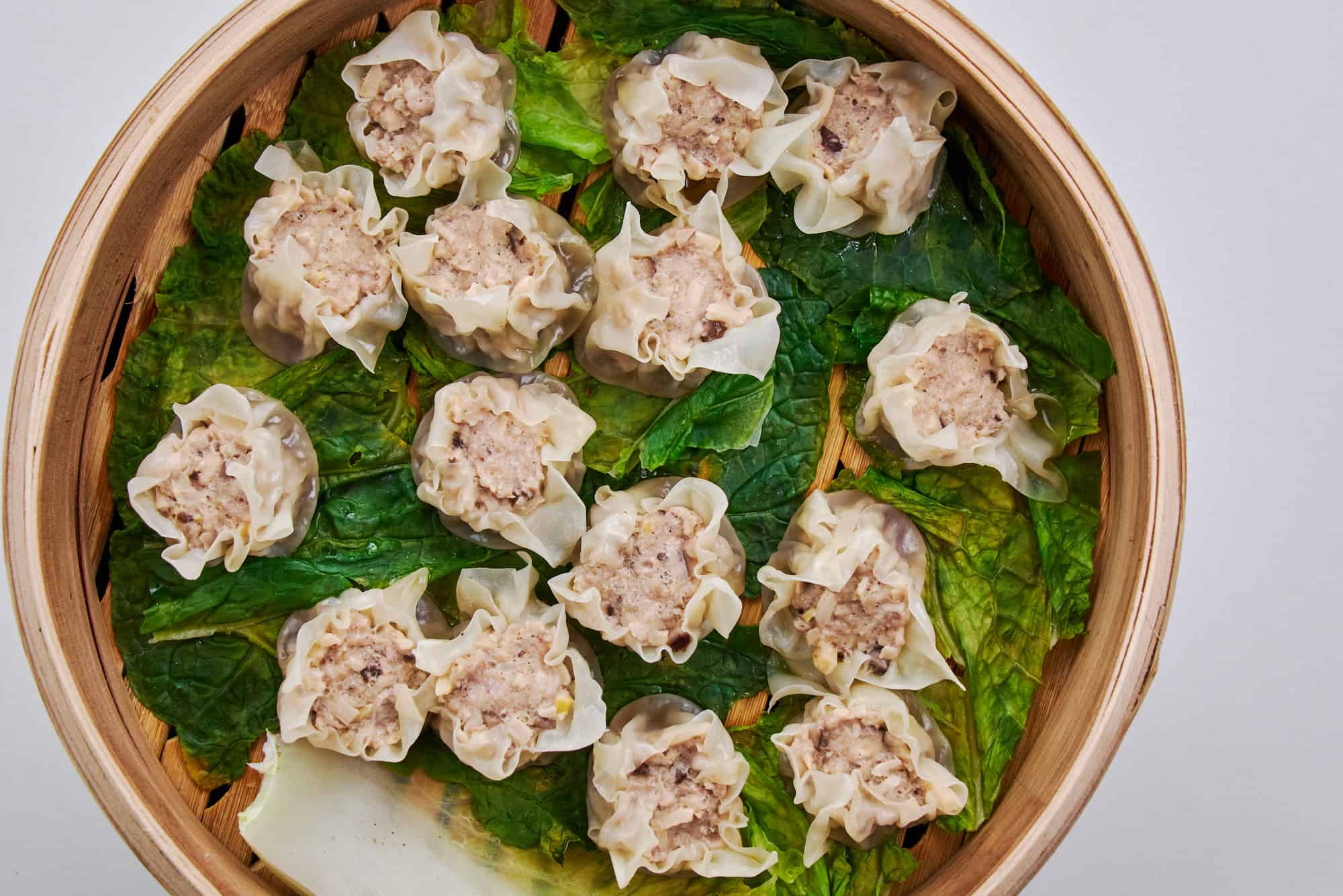 Shumai steamed on cabbage leaves.