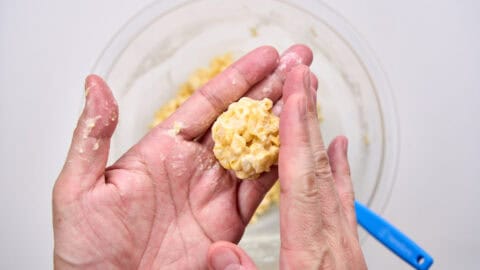Forming the balls of corn tempura.