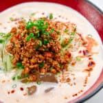 Slippery somen noodles in a creamy broth topped with spicy chicken.
