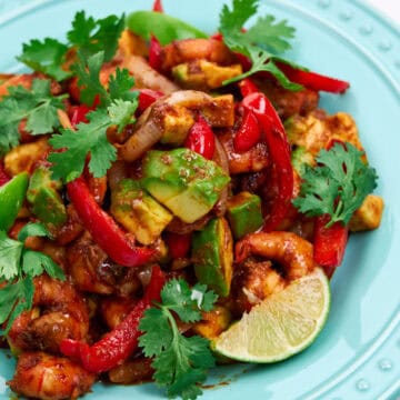 A plate of Chili Lime Shrimp garnished with cilantro and lime.