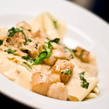 Scallops and basil in a cream sauce.