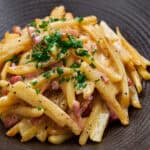 Batons of potato cooked with pancetta and coated in a silky egg sauce.