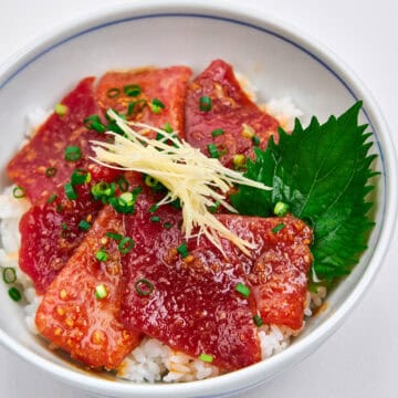 Sliced and marinated tuna in a bowl with rice.