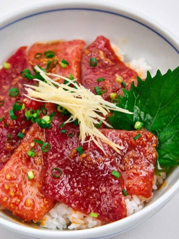 Sliced and marinated tuna in a bowl with rice.