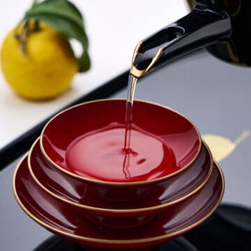 Pouring otoso into traditional lacquered cups.