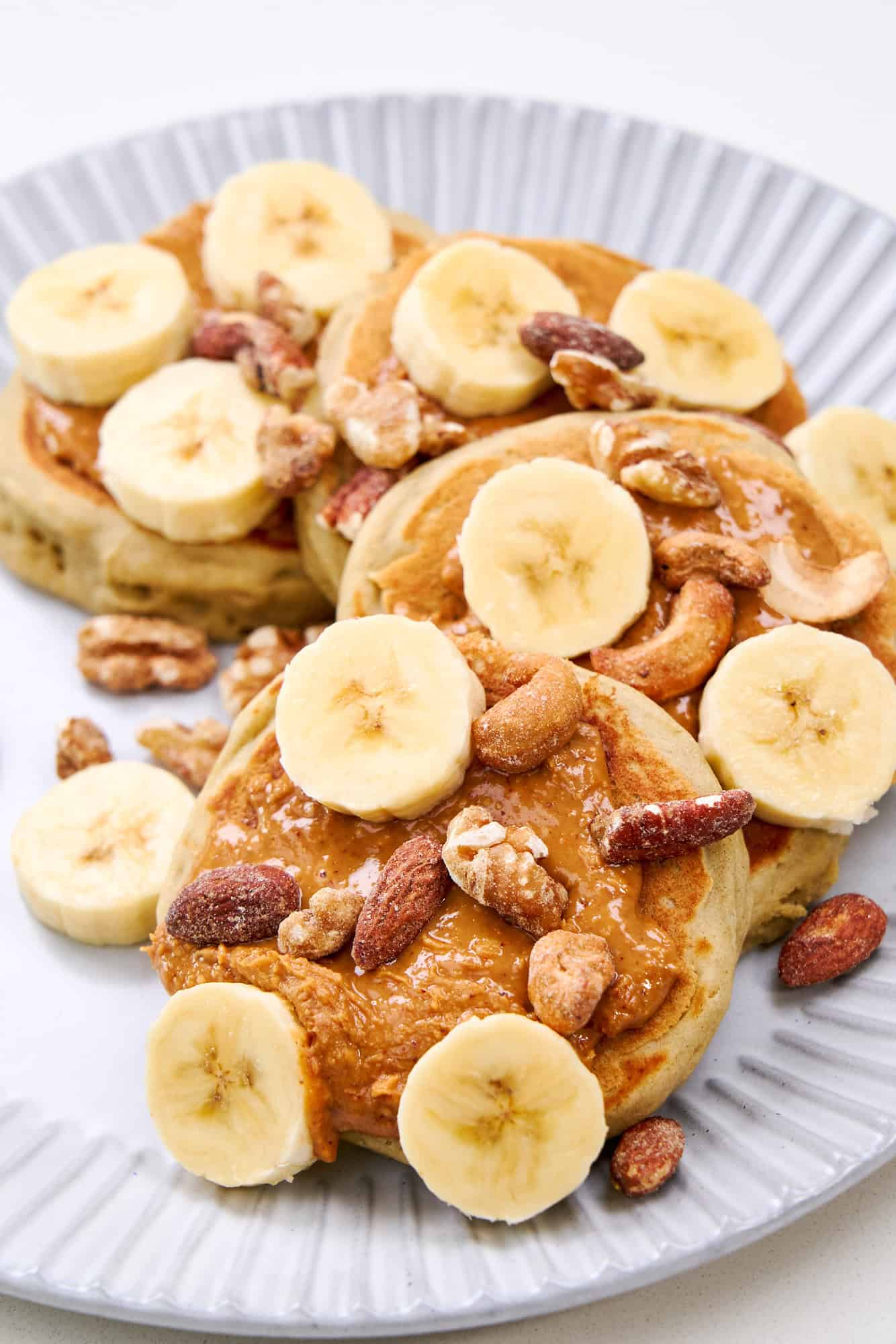 Fluffy Buckwheat Pancakes served with bananas and nuts.