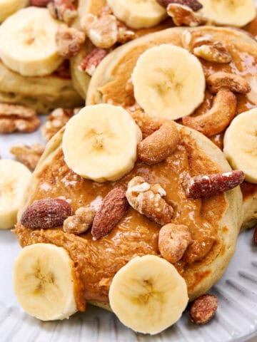 Fluffy Buckwheat Pancakes served with bananas and nuts.
