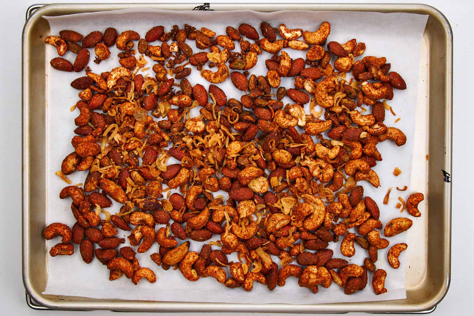 Spicy nuts cooling on a tray.