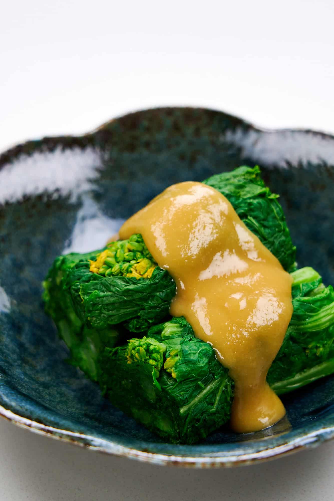 Nanohana dressed with a tangy sauce.