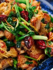 Firecracker chicken with wilted greens and dried chilies.