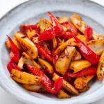 Crispy lotus root spears mingling with sweet red bell peppers in a garlicky olive oil.