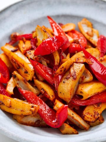 Crispy lotus root spears mingling with sweet red bell peppers in a garlicky olive oil.