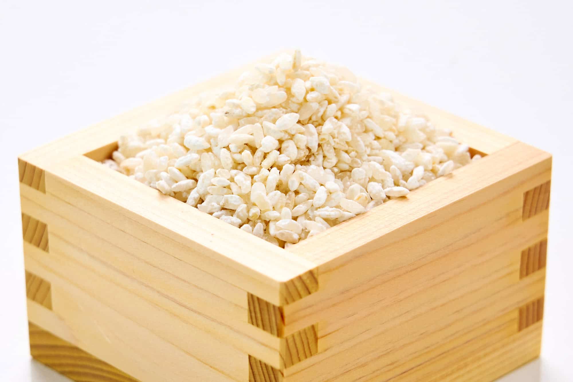 A masu brimming with rice koji.