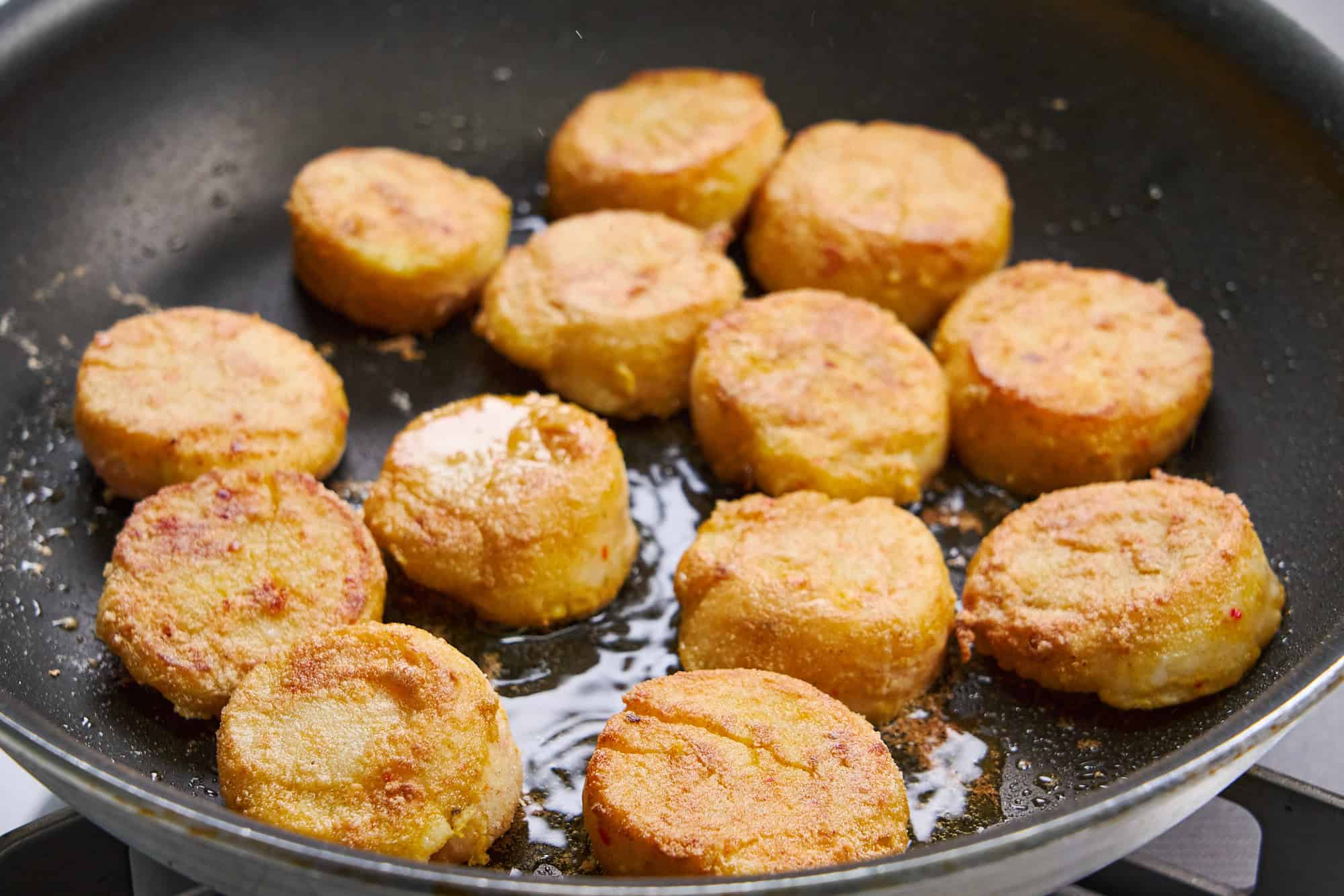Scallops frying until golden.