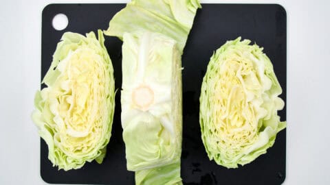 Slicing the steak from a head of cabbage.