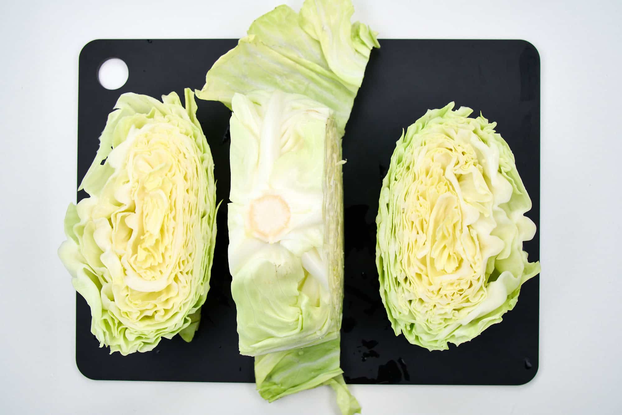 Slicing the steak from a head of cabbage.