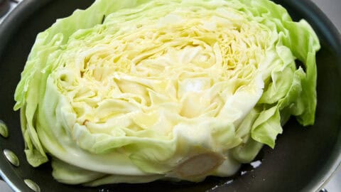 Green cabbage "steak" ready to be caramelized in olive oil.