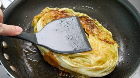 Pushing down on the cabbage ensures it gets good contact with the pan.