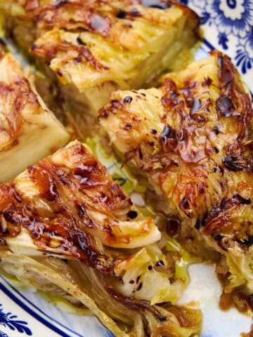 Crispy, golden pan fried cabbage steak ready to serve.