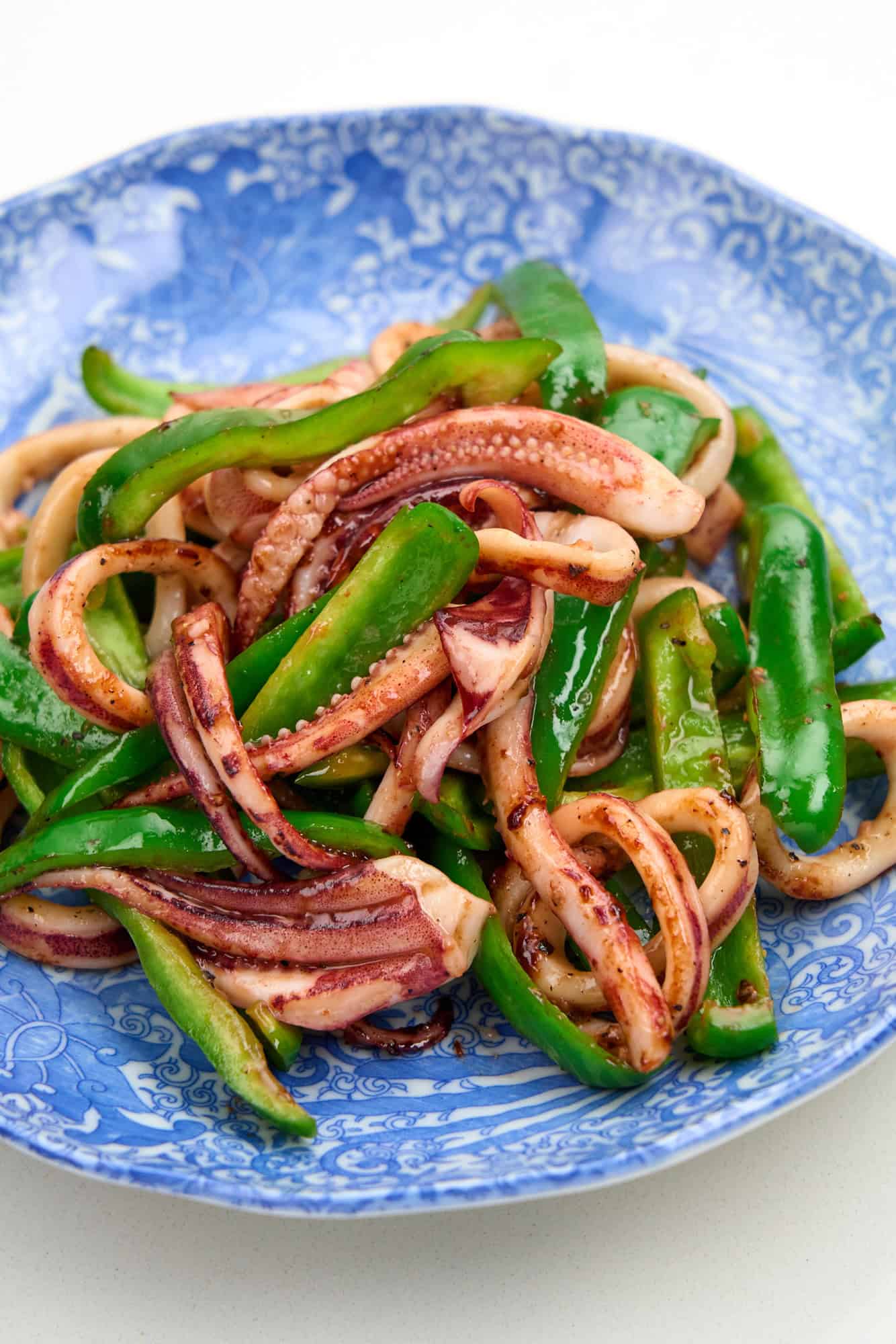 A plate of succulent squid and tender, crisp green bell peppers.