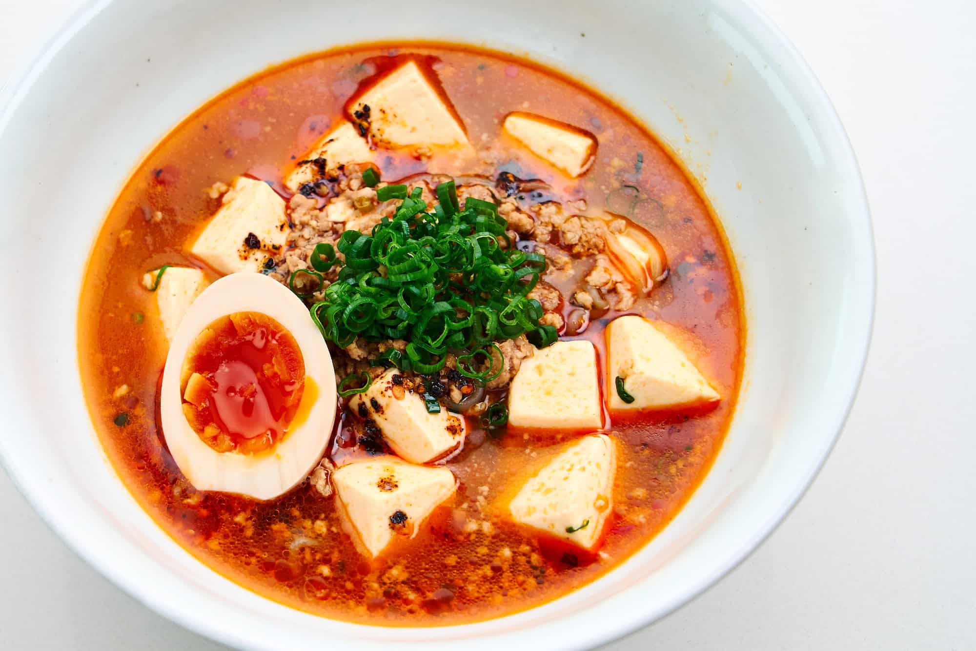 Spicy Mapo Tofu Noodle Soup with a ramen egg.